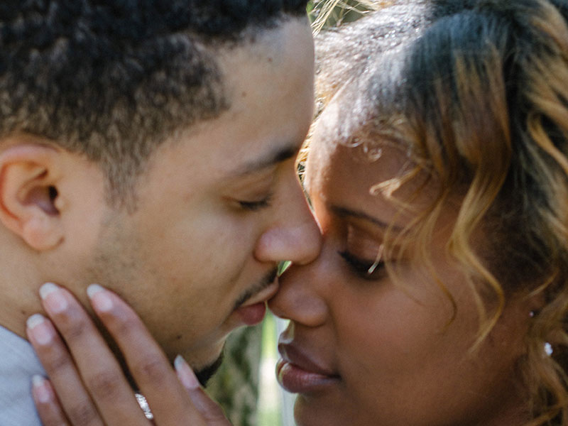 A woman who's wondering how do you know you love someone, kissing her boyfriend and wondering.