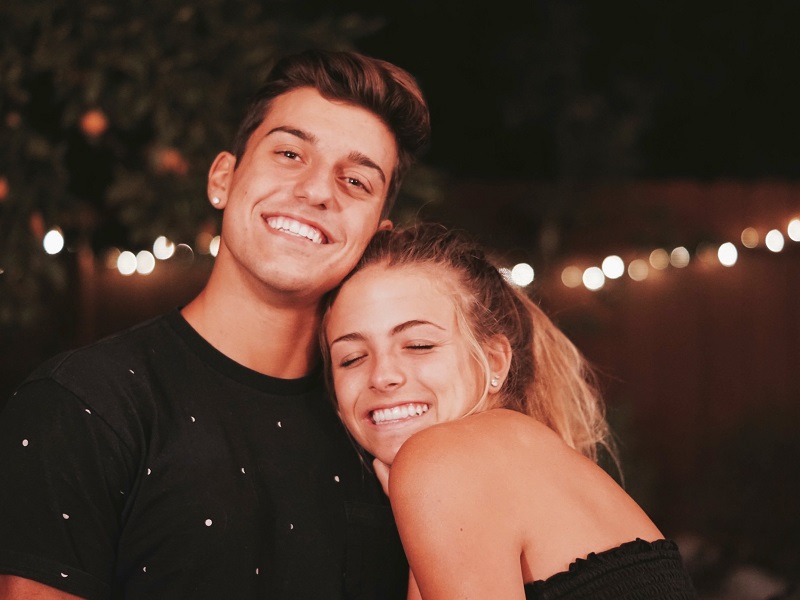 A guy and girl are together smiling. She likes him more than a friend.