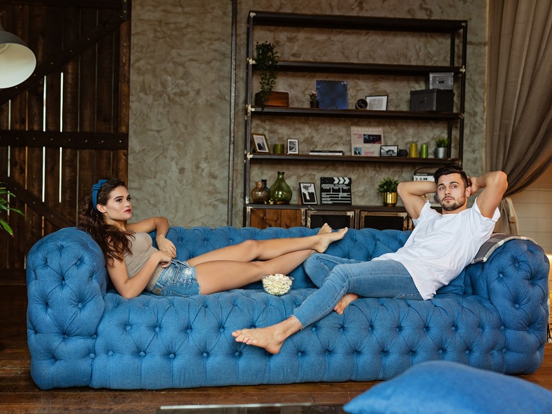 a couple lying on the sofa at home in quarantine during coronavirus outbreak