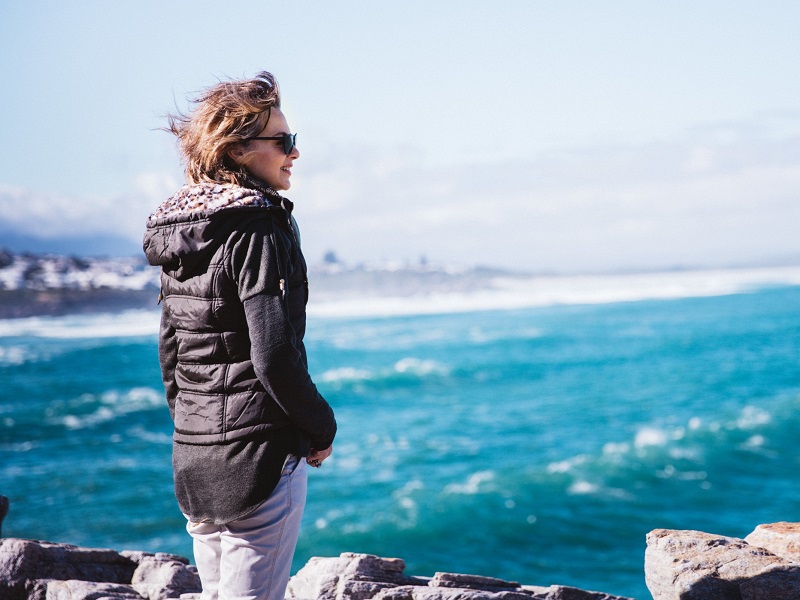 50 and single again woman looking out at ocean