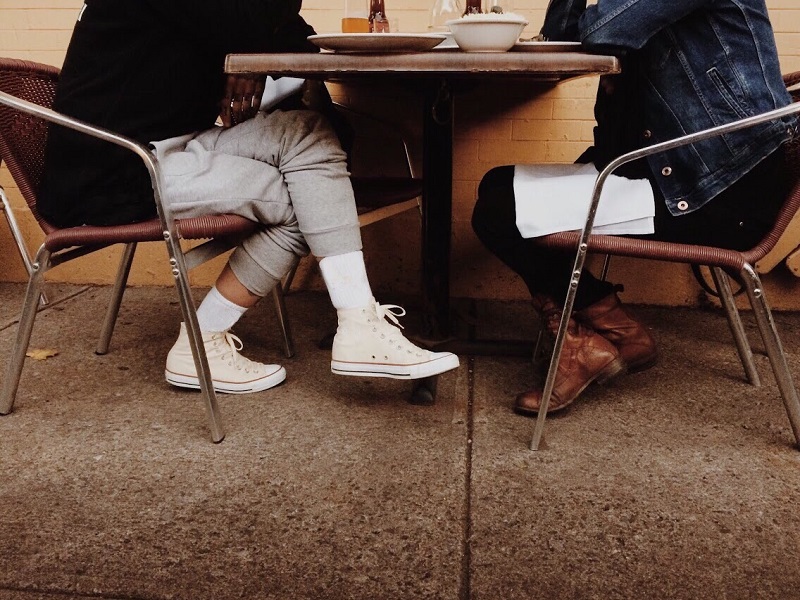 couple sitting at table speaking about boundaries in relationships