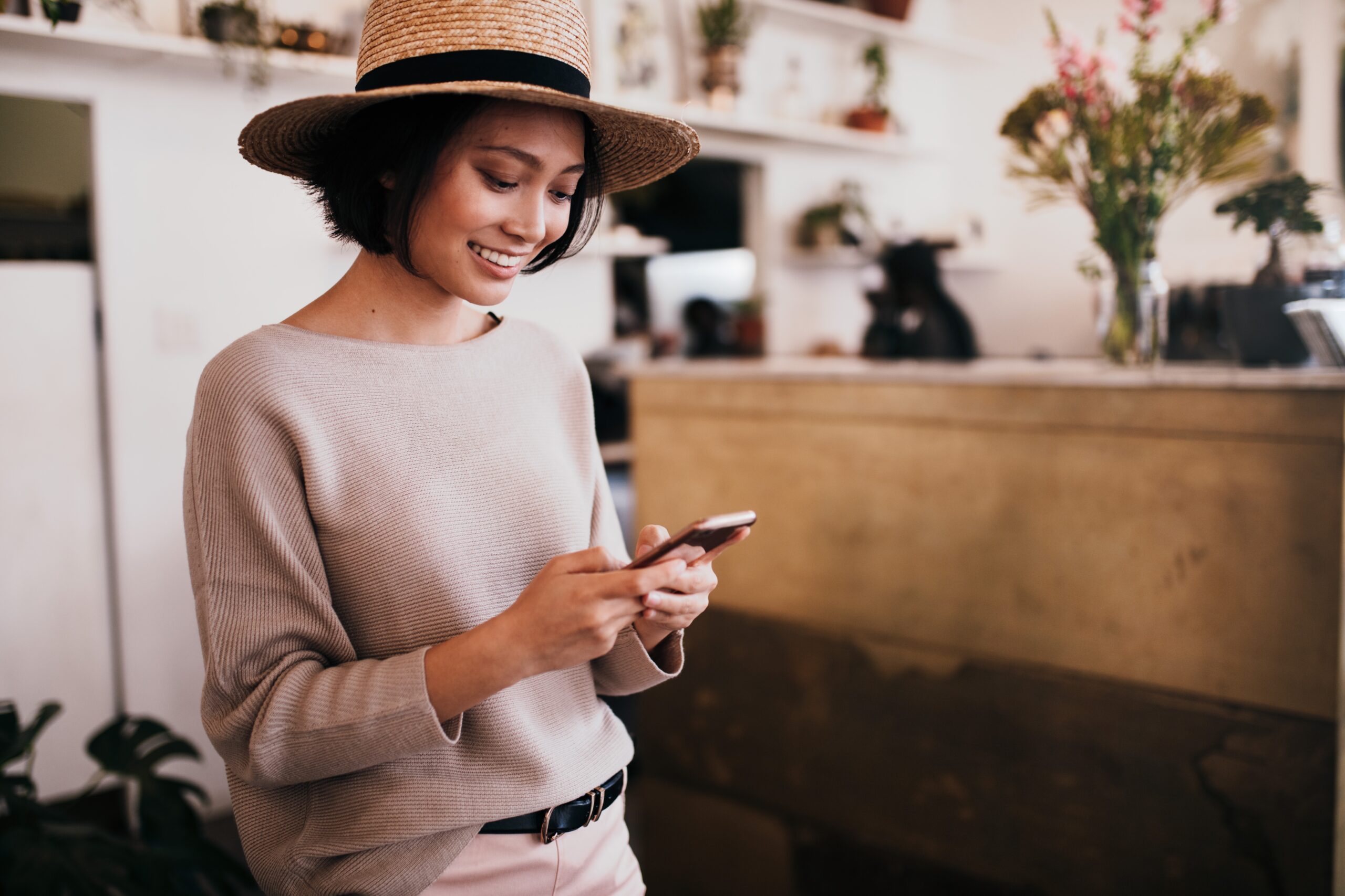 Attractive woman smiling and using dating apps on her phone