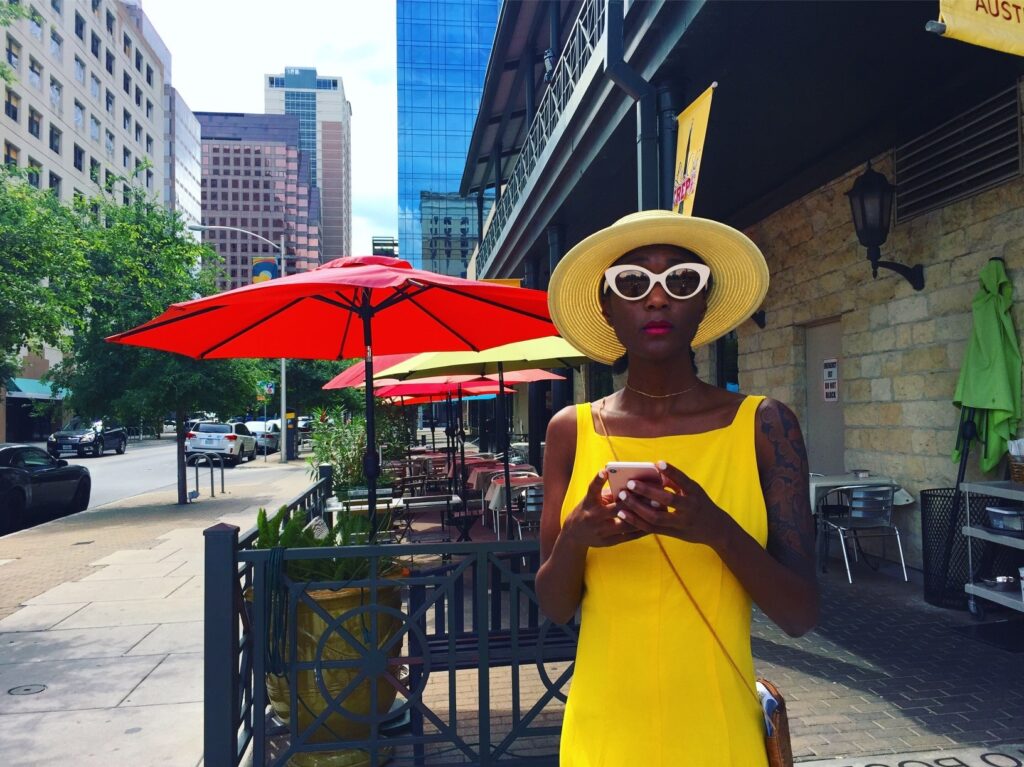 single woman using phone on street in Austin for online dating