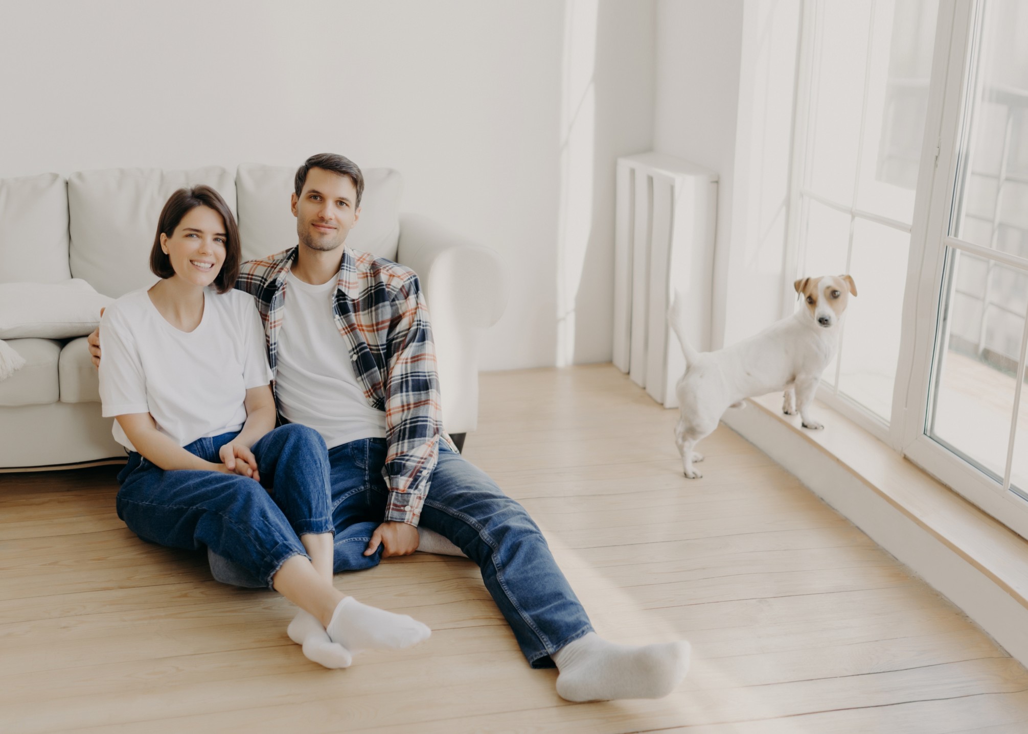 couple in their 30s sitting in the lounge laughing