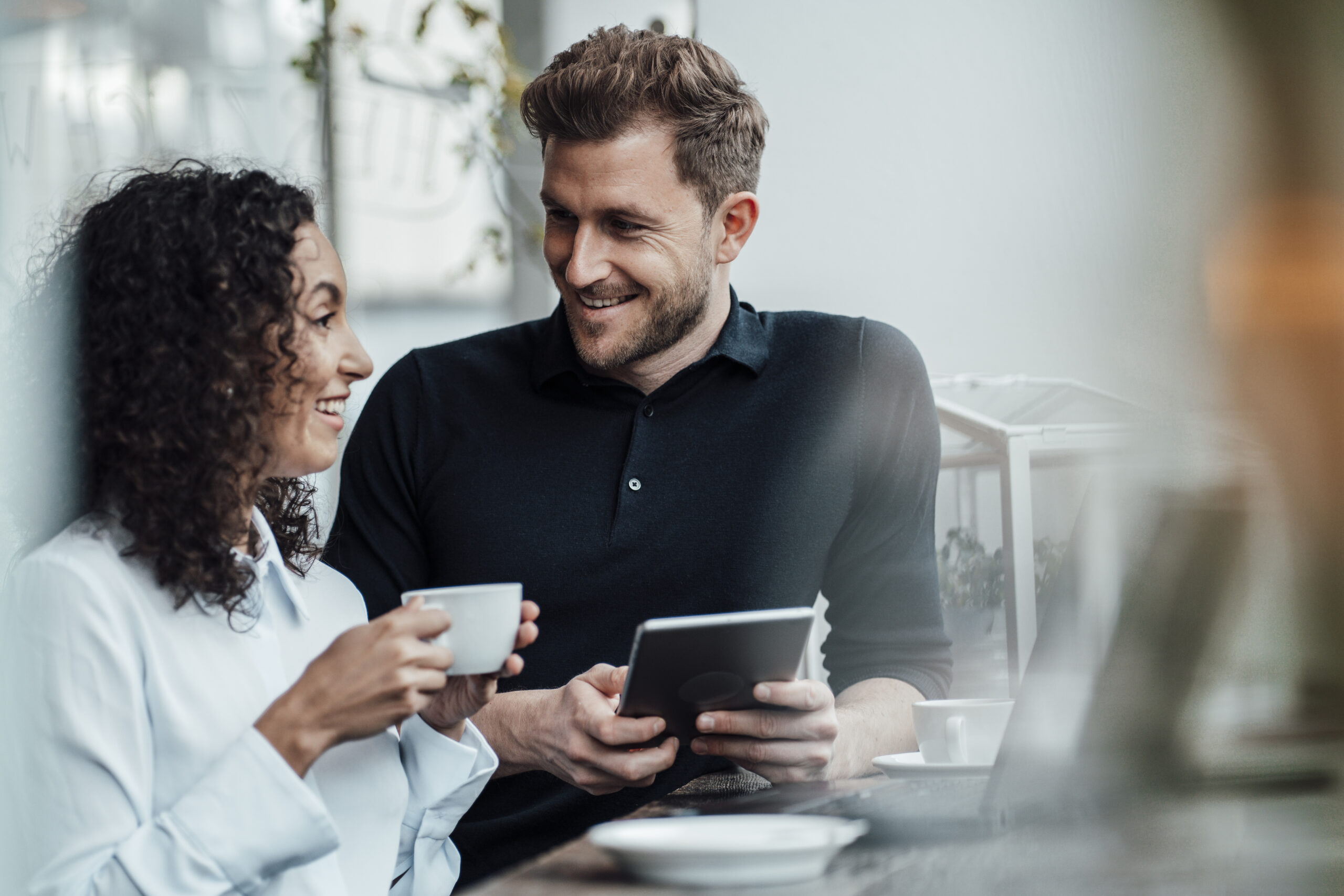 Happy couple looking into each other's eyes and laughing after meeting on a teacher dating site.