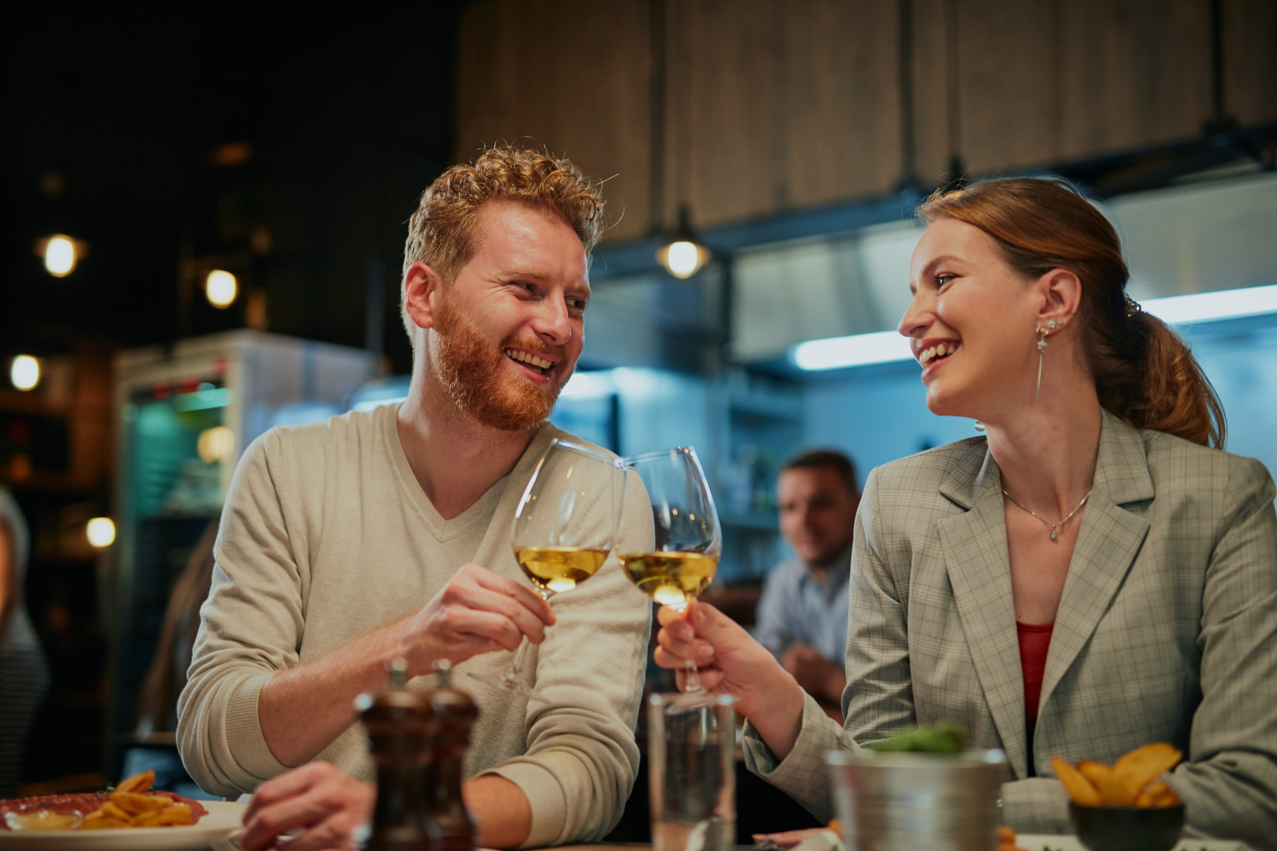 Happy couple looking into each other's eyes and enjoying an evening in one of the best date night restaurants in NYC.